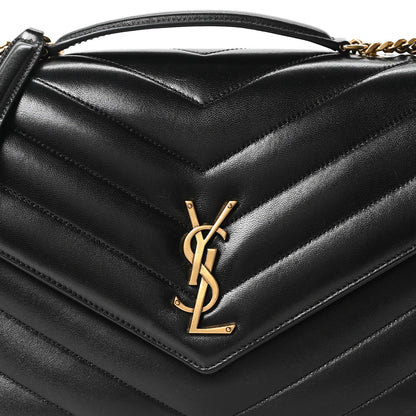 Black chevron-quilted flap front with gold YSL logo