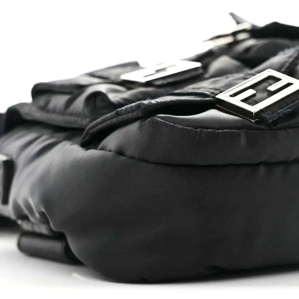 Fendi Econyl black nylon baguette bag close-up of logo hardware and padded texture