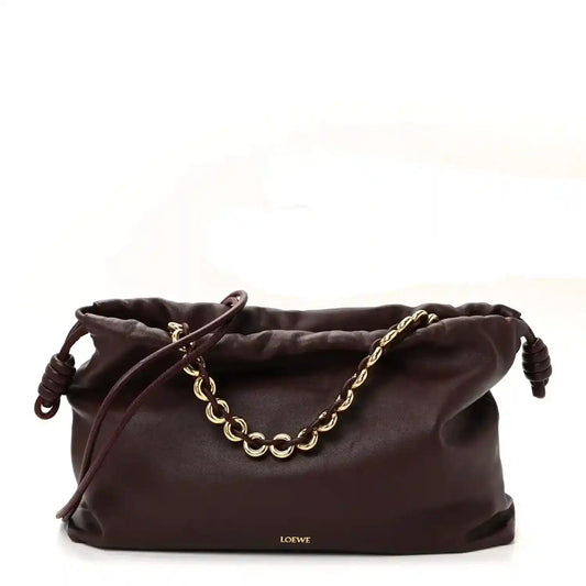 Dark burgundy leather clutch with drawstring knot pulls and gold chain