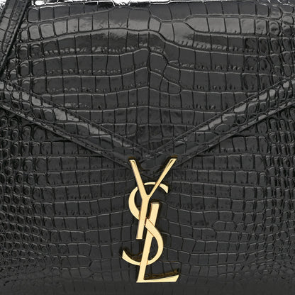Black crocodile-embossed bag front with gold YSL logo clasp