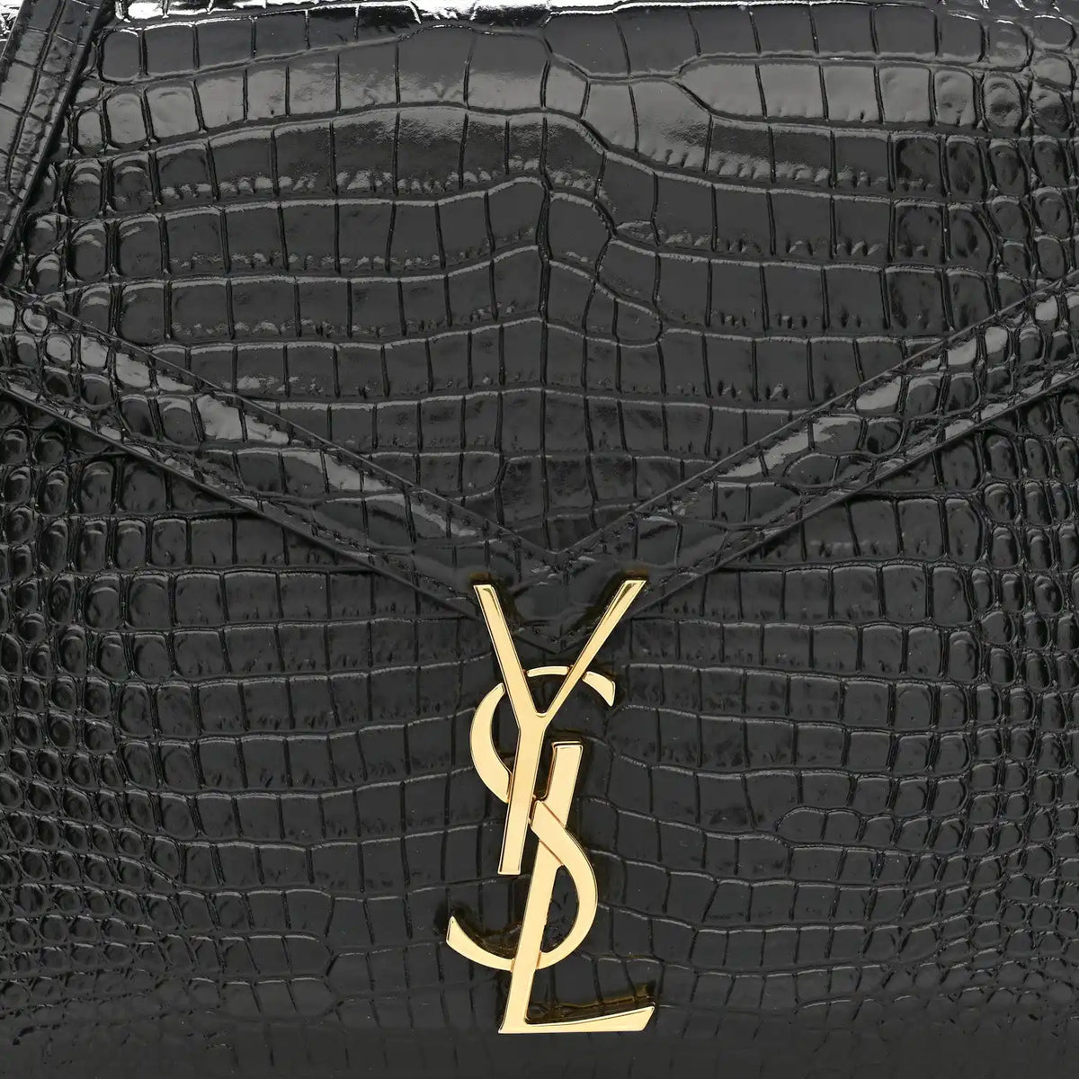 Black crocodile-embossed bag front with gold YSL logo clasp