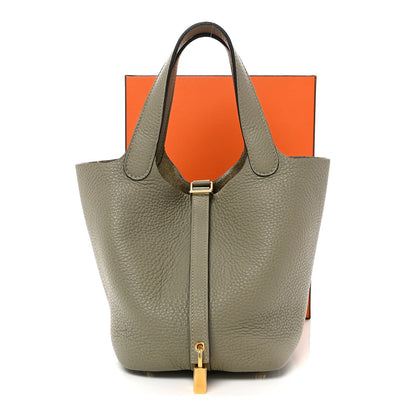 Sauge leather tote bag with top handles and gold lock hardware, front view