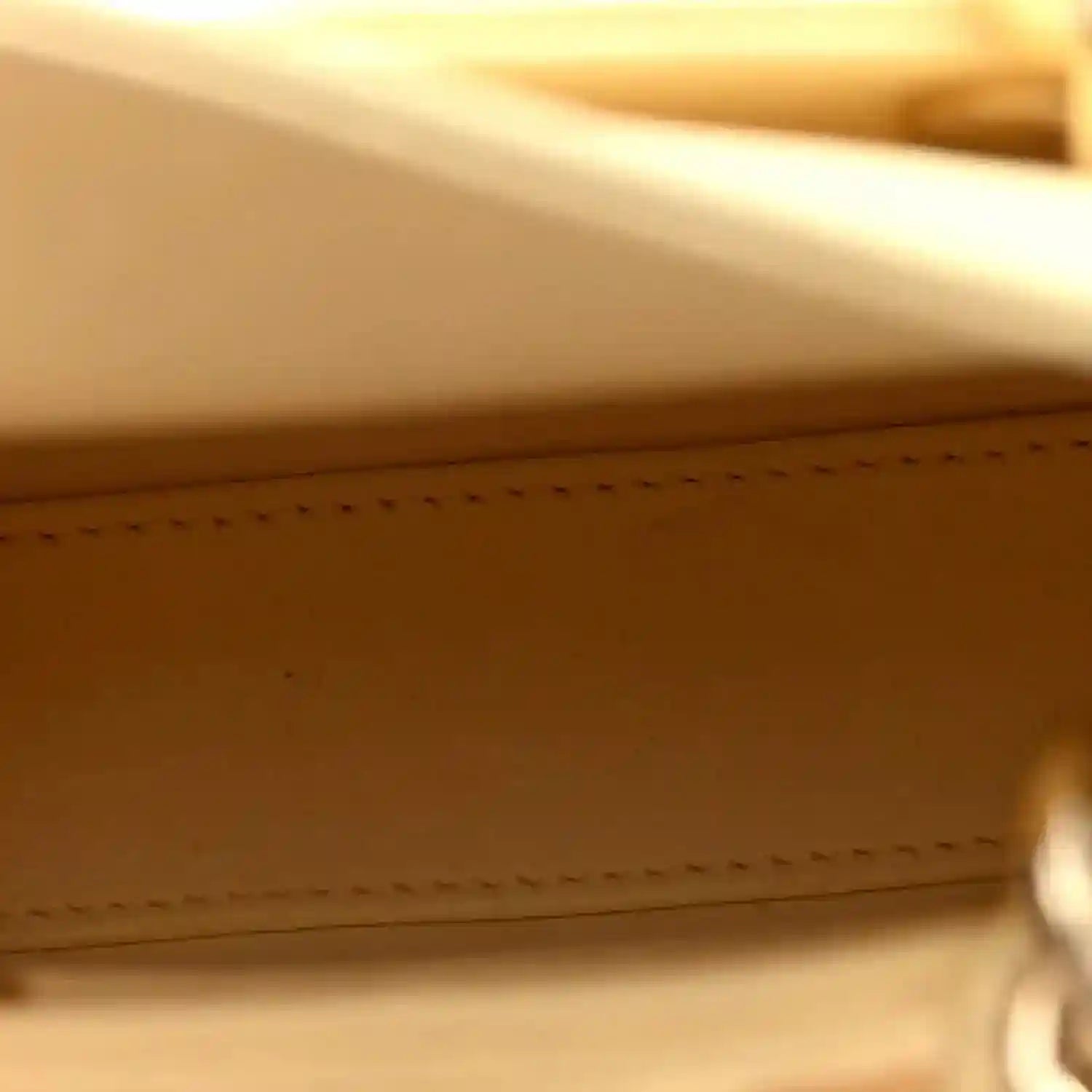 Soft yellow lambskin interior panel with edge stitching and smooth lining