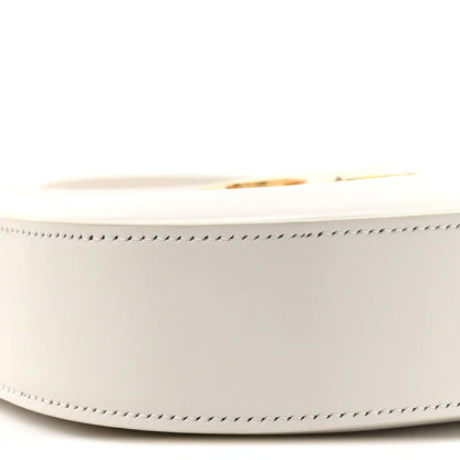 Close-up of rice cream bag side with gold-tone zipper pull and stitched trim