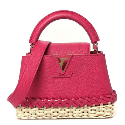 Louis Vuitton mini handbag in magenta pebbled leather with gold LV logo and rattan base