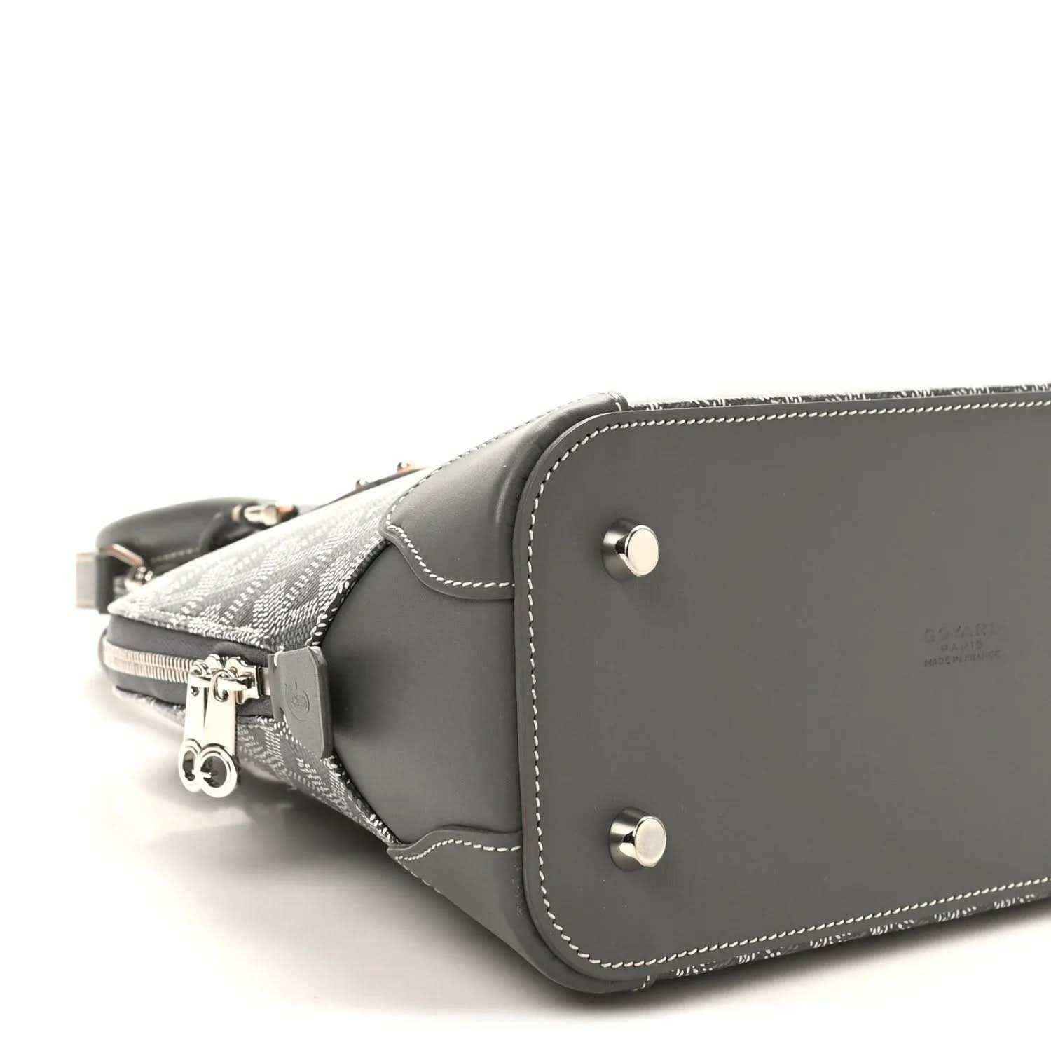 Grey handbag with silver snap hardware, dark leather trim, and zipper end.