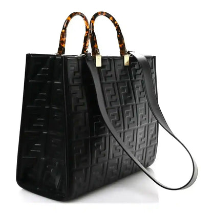 Black leather tote bag with embossed FF pattern, top handles, detachable shoulder strap
