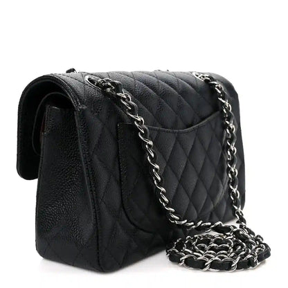 Black quilted leather flap bag with chain strap and structured side silhouette