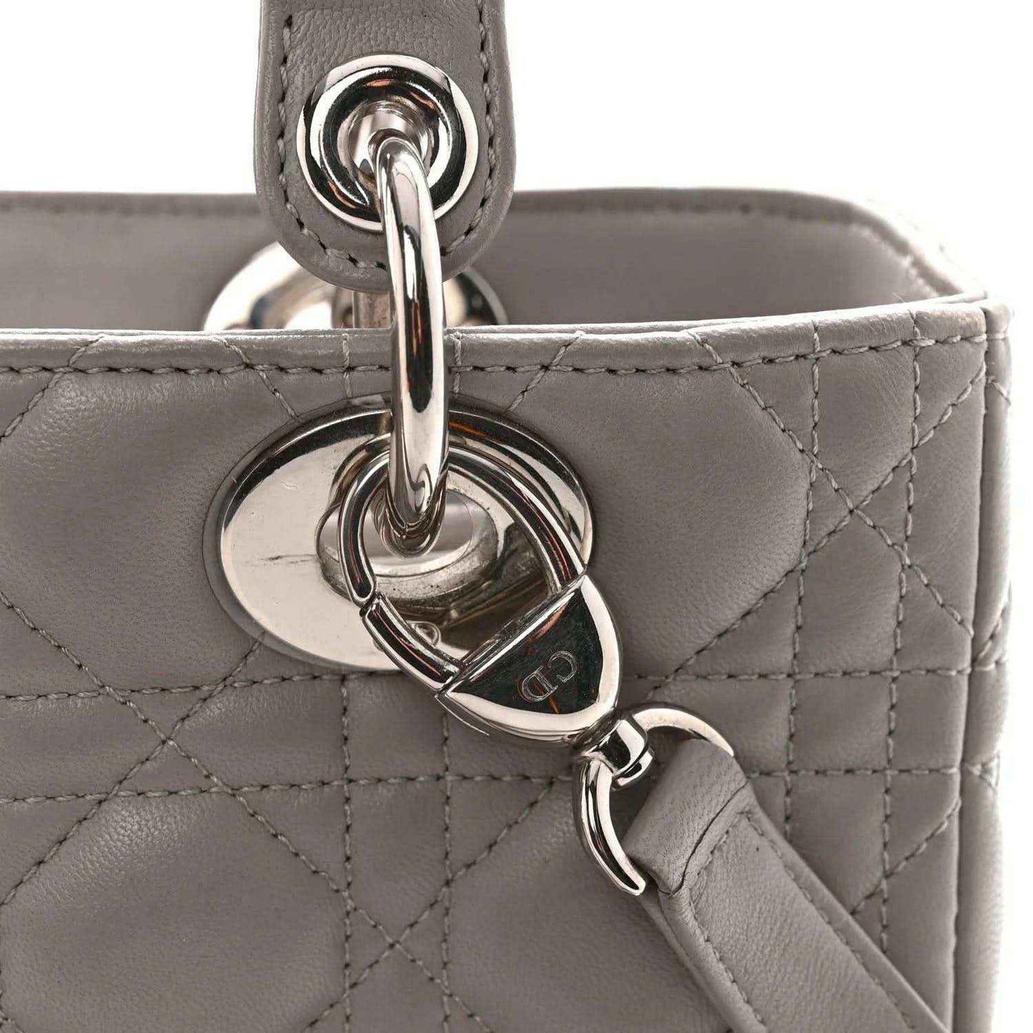 Grey quilted handbag with heart-shaped metal key ring charm and chain clasp