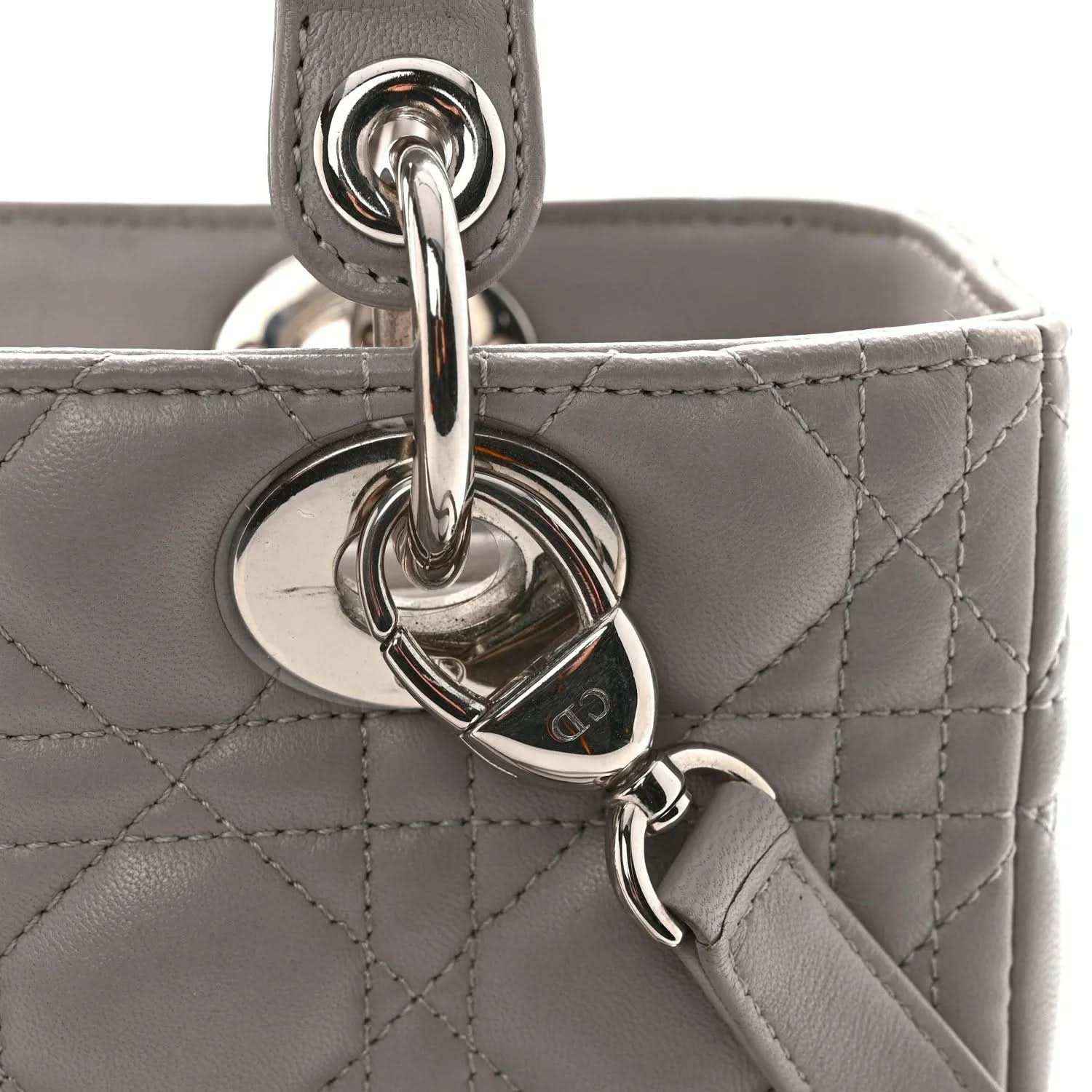 Grey quilted handbag with heart-shaped metal key ring charm and chain clasp