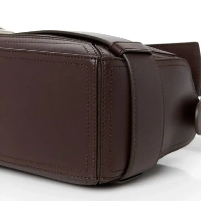 Loewe small puzzle biker bag in dark shiny calfskin leather, side view with handle