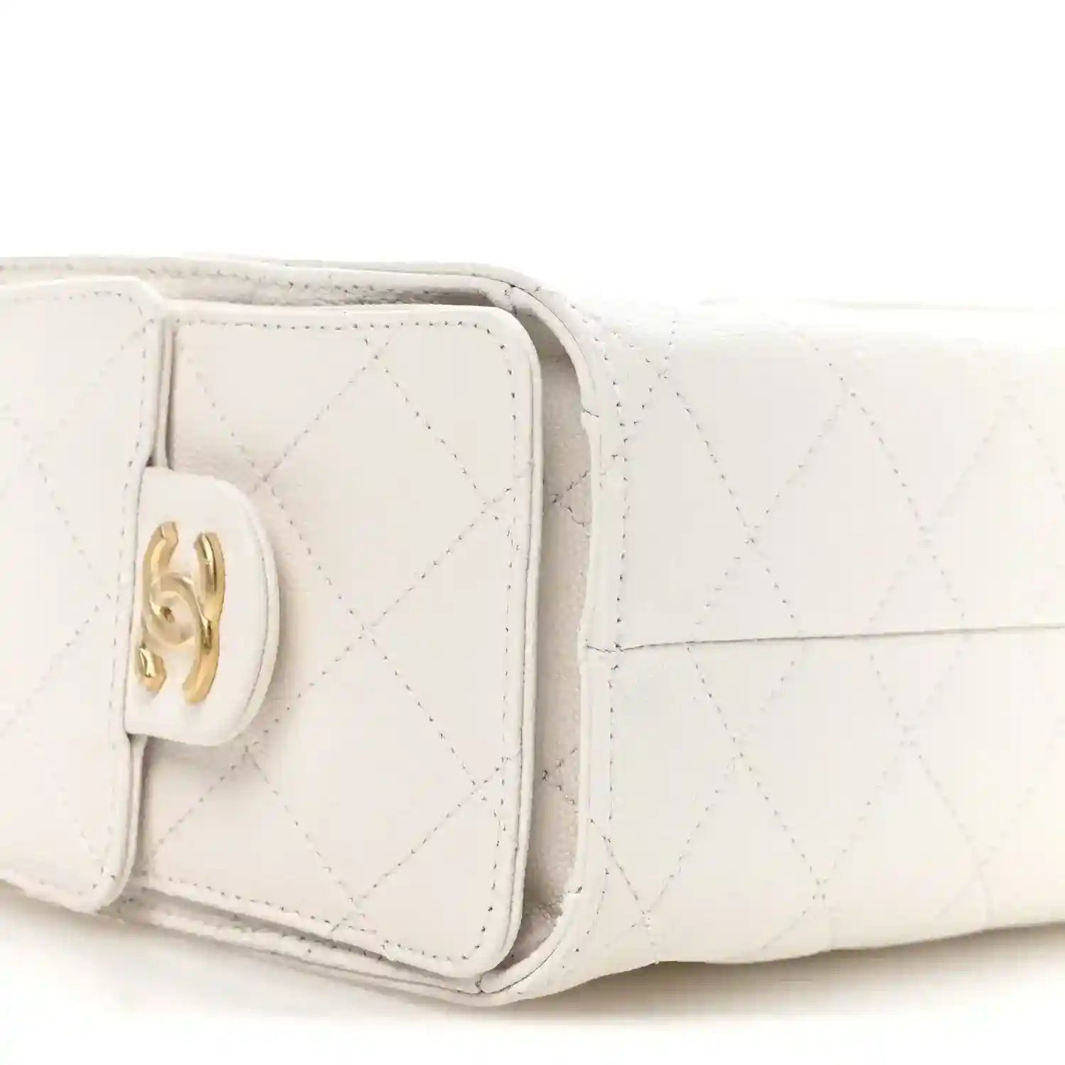 Pristine white quilted mini handbag flap with gold turn-lock clasp detail