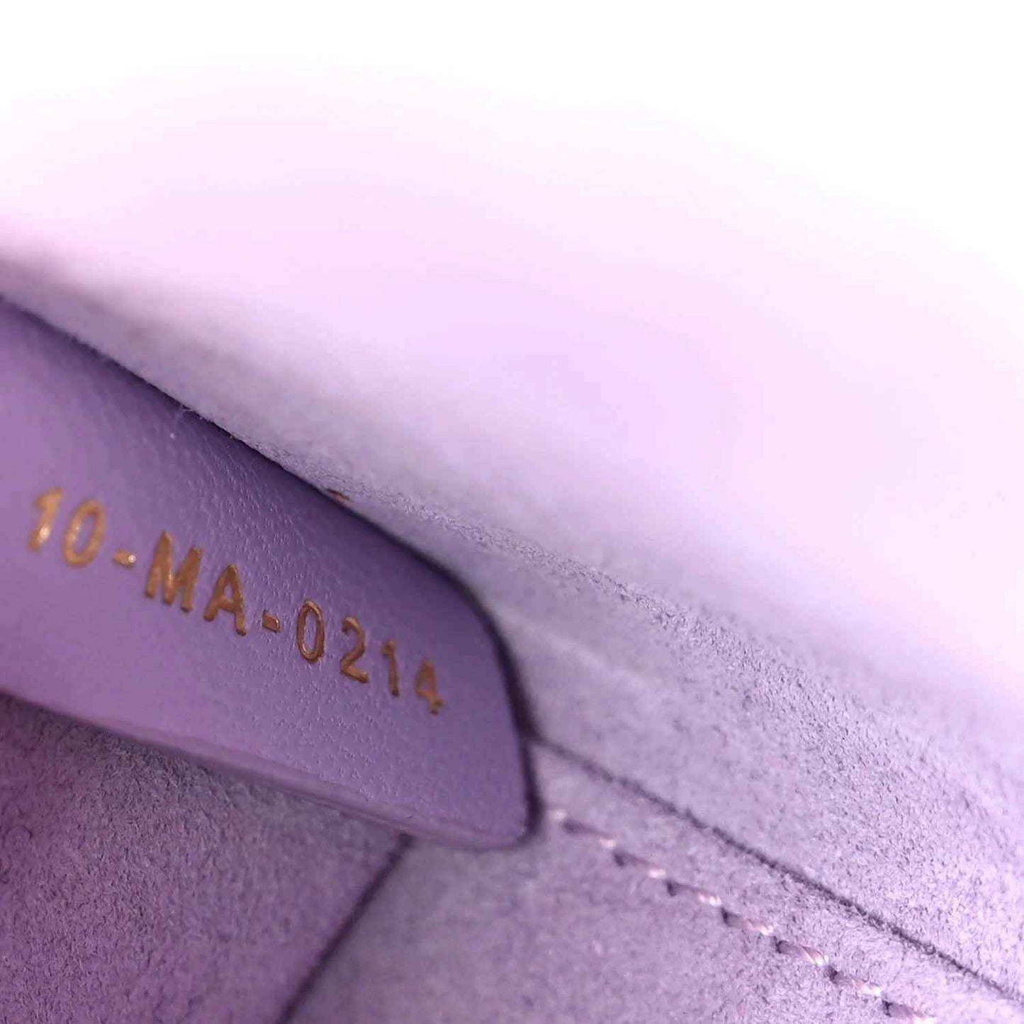 Lilac leather date code '10-MA-0219' with stitched edge