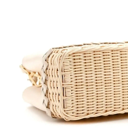 Louis Vuitton rattan handbag side with woven texture and leather trim