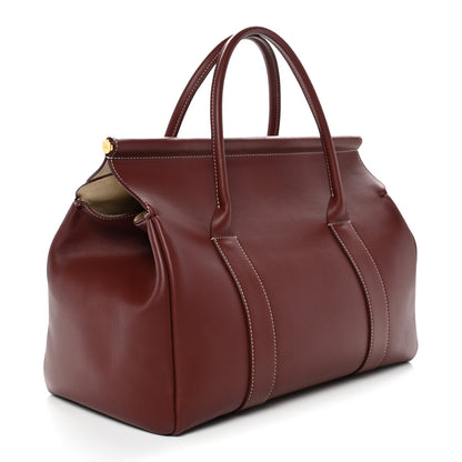 Calfskin loom bag with front pocket, top handles, and stitched details, dark brown