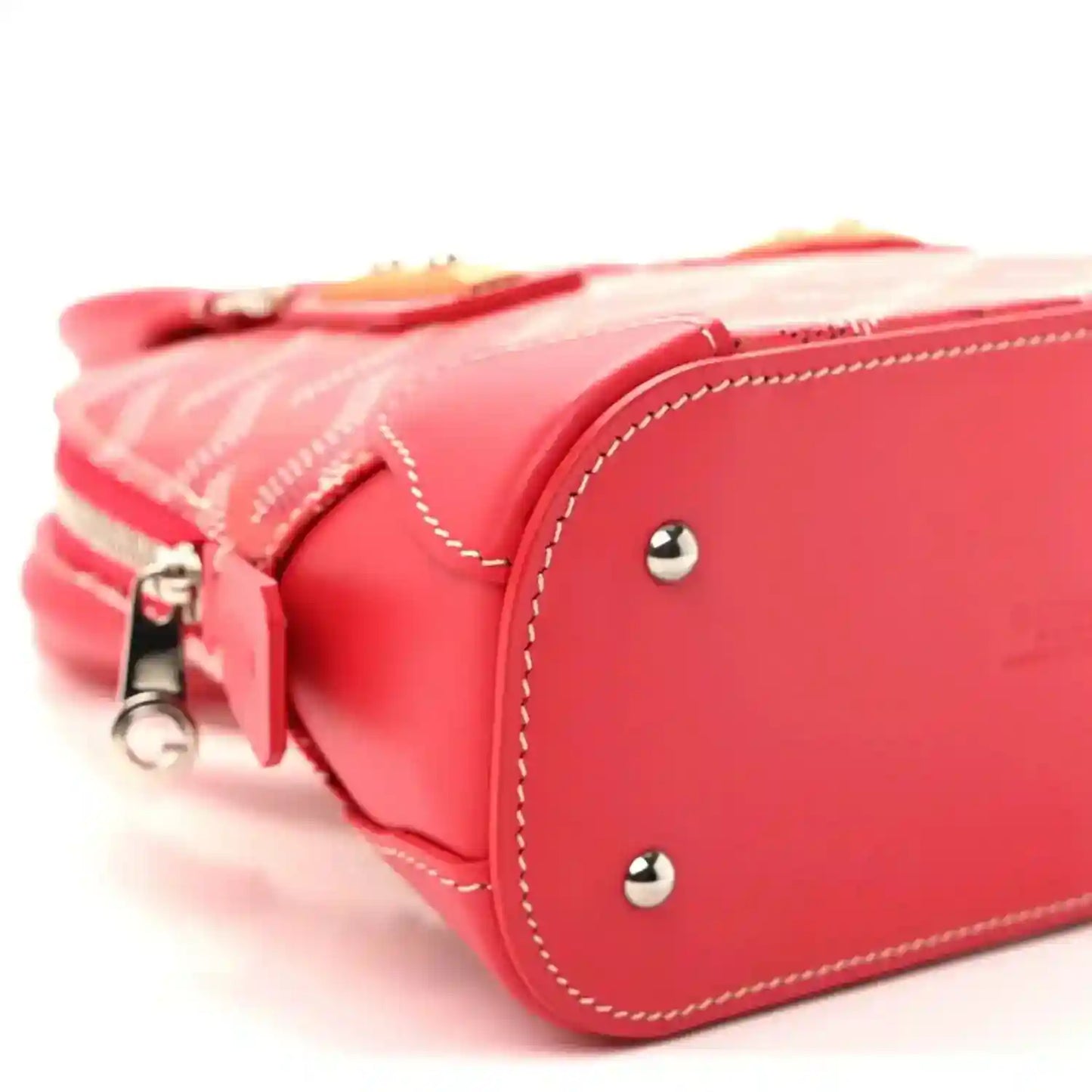Red mini handbag side view with zipper pull, stitched trim, and silver stud details