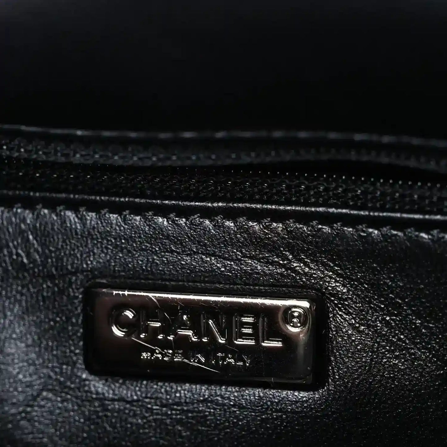 Black satin lining with Chanel logo plaque at inner side seam