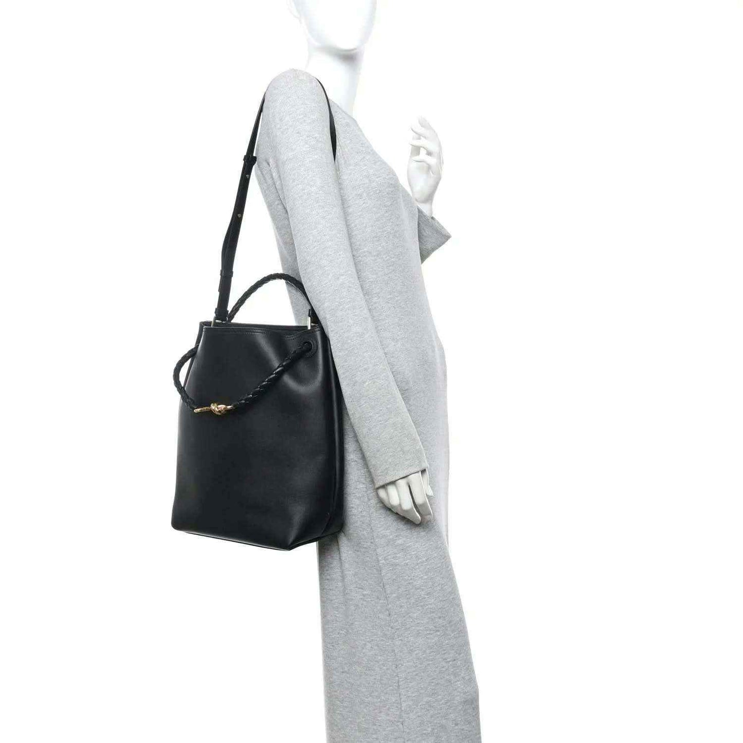 Black bucket bag with braided handle and leather shoulder strap