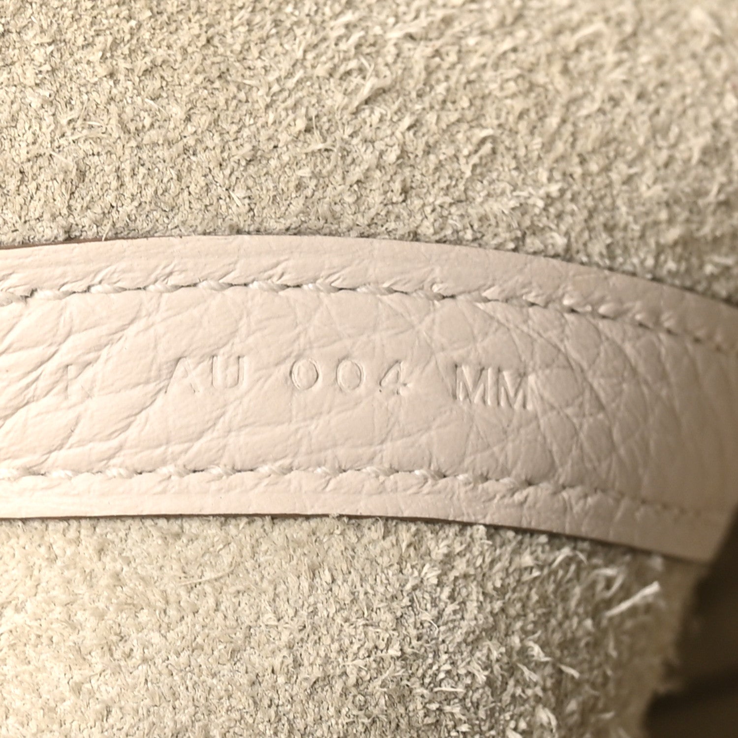 Pale cream leather lining with embossed size marking, side panel close-up