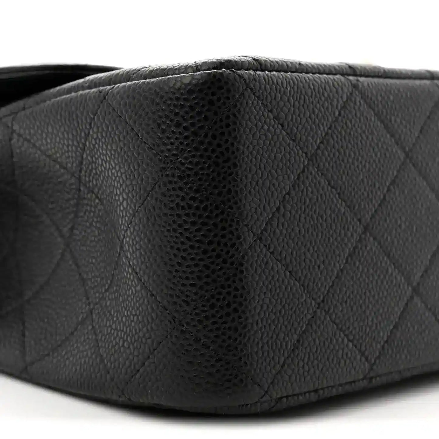 Chanel double flap bag side close-up in black quilted caviar leather