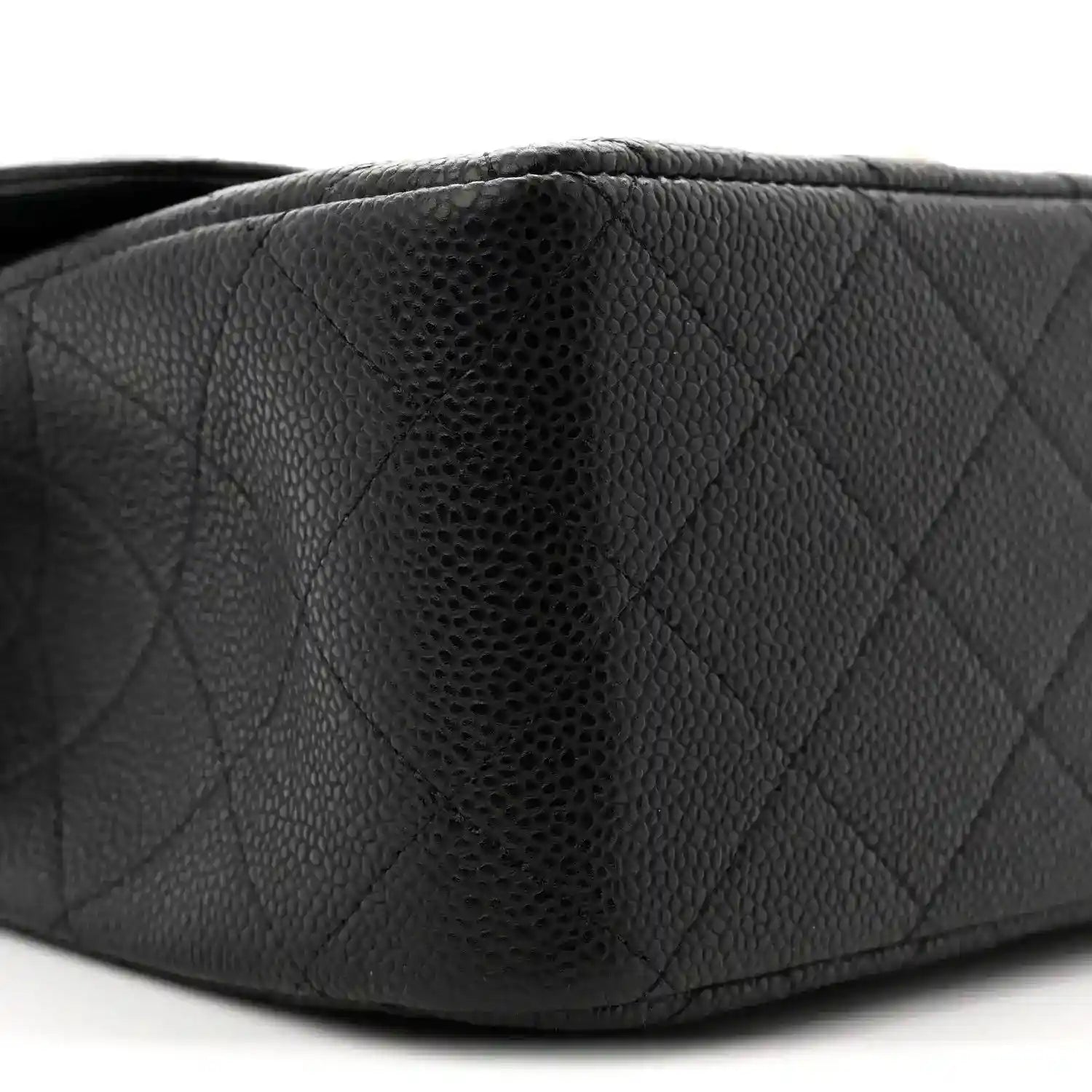 Chanel double flap bag side close-up in black quilted caviar leather