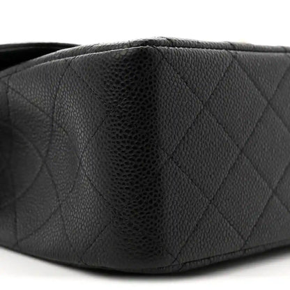 Chanel double flap bag side close-up in black quilted caviar leather