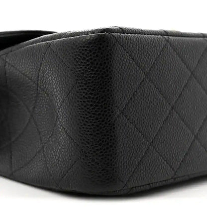 Chanel double flap bag side close-up in black quilted caviar leather