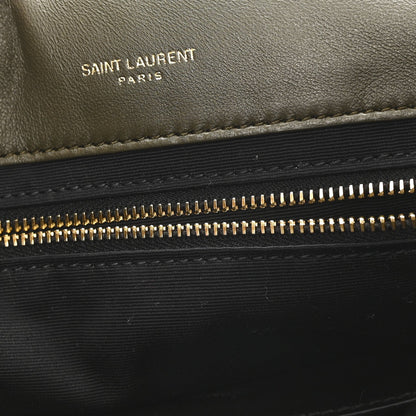 Black leather shearling bag panel with “SAINT LAURENT PARIS” text and zipper