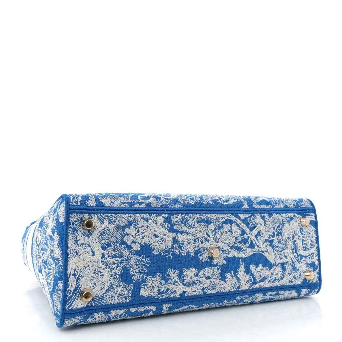 Blue embroidered rectangular clutch-style bag with metal snaps on the flap.