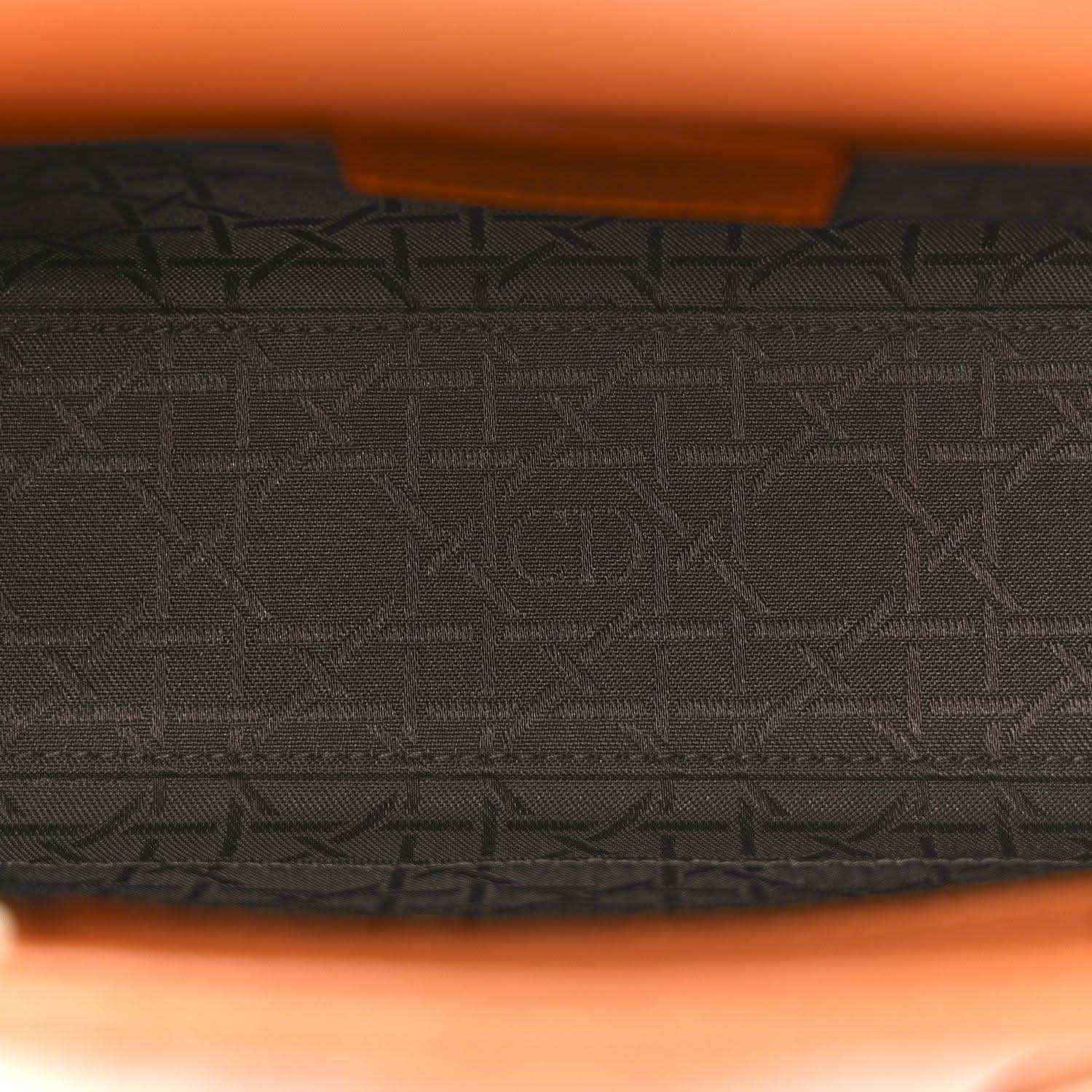 Inside view of small orange quilted Lady Dior tote with dark jacquard lining
