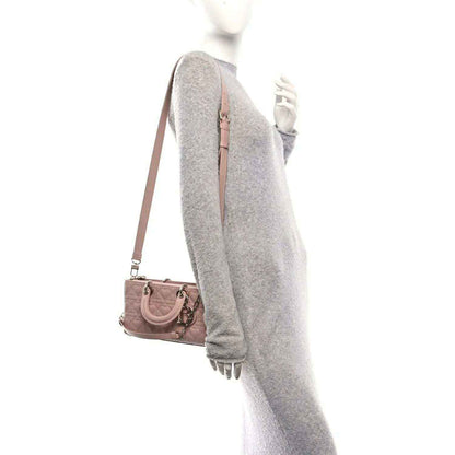 Medium lambskin handbag in pale pink, styled crossbody with adjustable strap