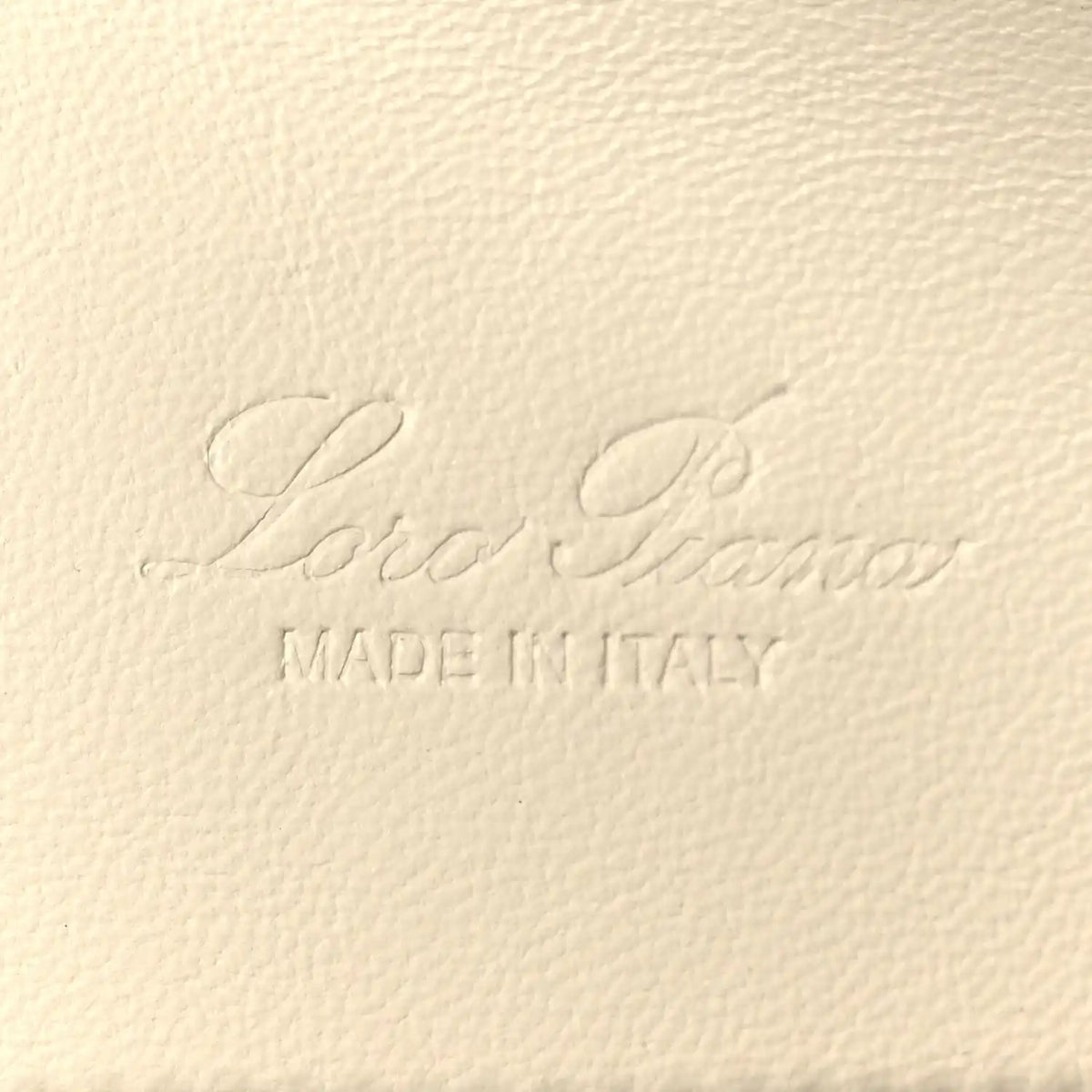 Embossed leather logo text and 'MADE IN ITALY' on grained calfskin