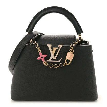 Black leather handbag with gold chain strap, top handle, and LV logo charm