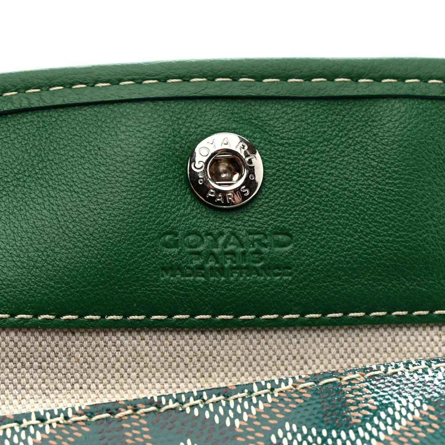 Green leather tote with round metal snap button and embossed logo