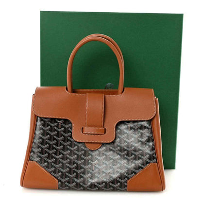 Goyard Saigon tote handbag front view with tan leather flap and dark monogram canvas