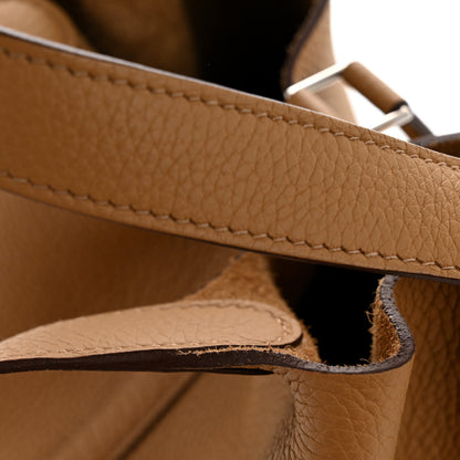 Biscuit brown leather bucket bag seam and top edge detail