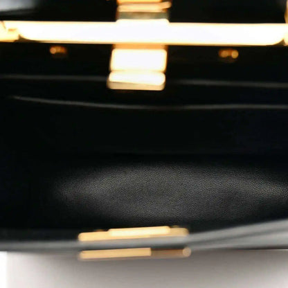 Black leather satchel close-up with fine grain texture