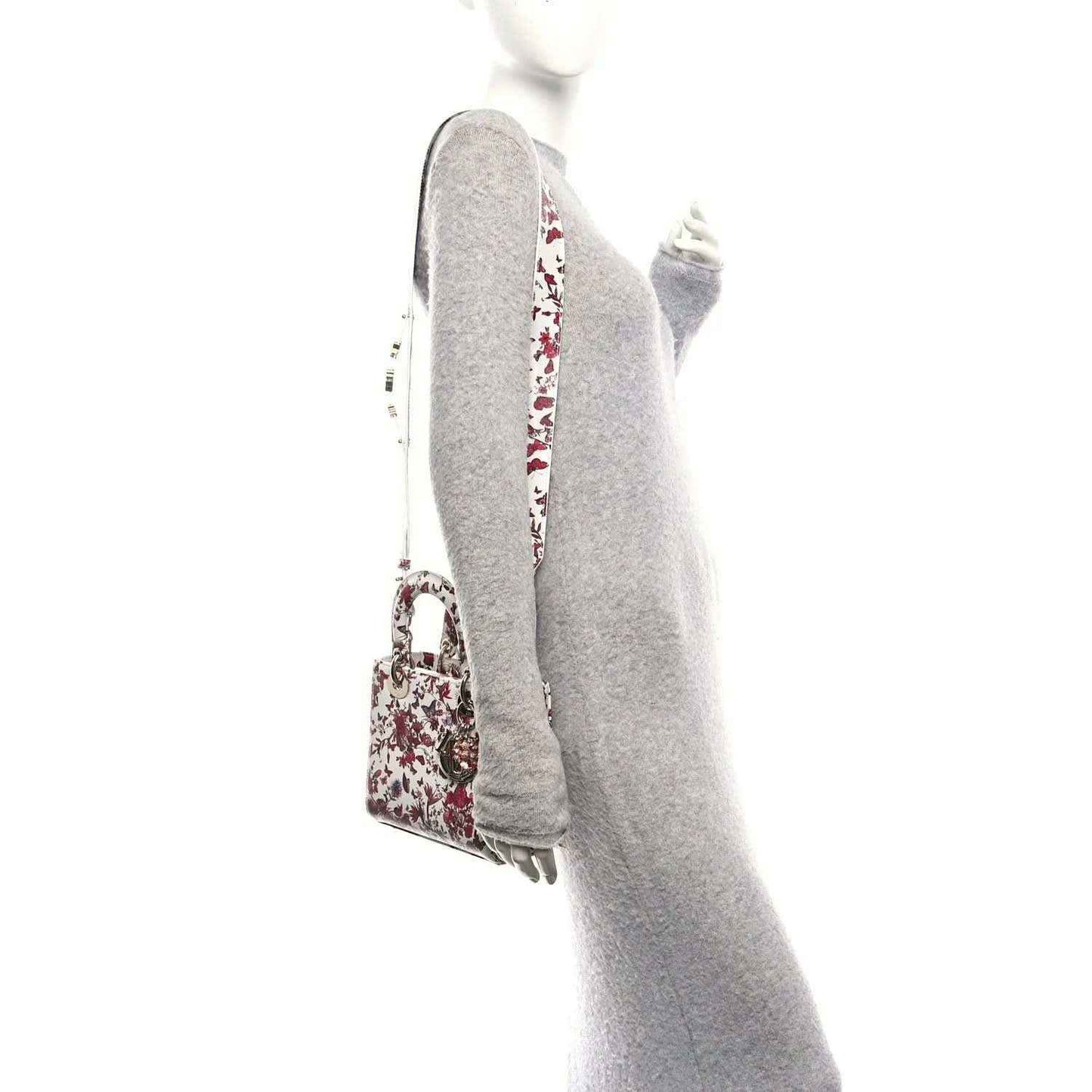 White and red floral handbag with one visible top handle and gold-tone side hardware