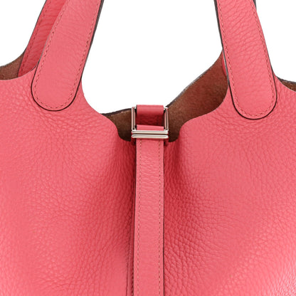 Pink leather tote handles with metal lock clasp and brown interior