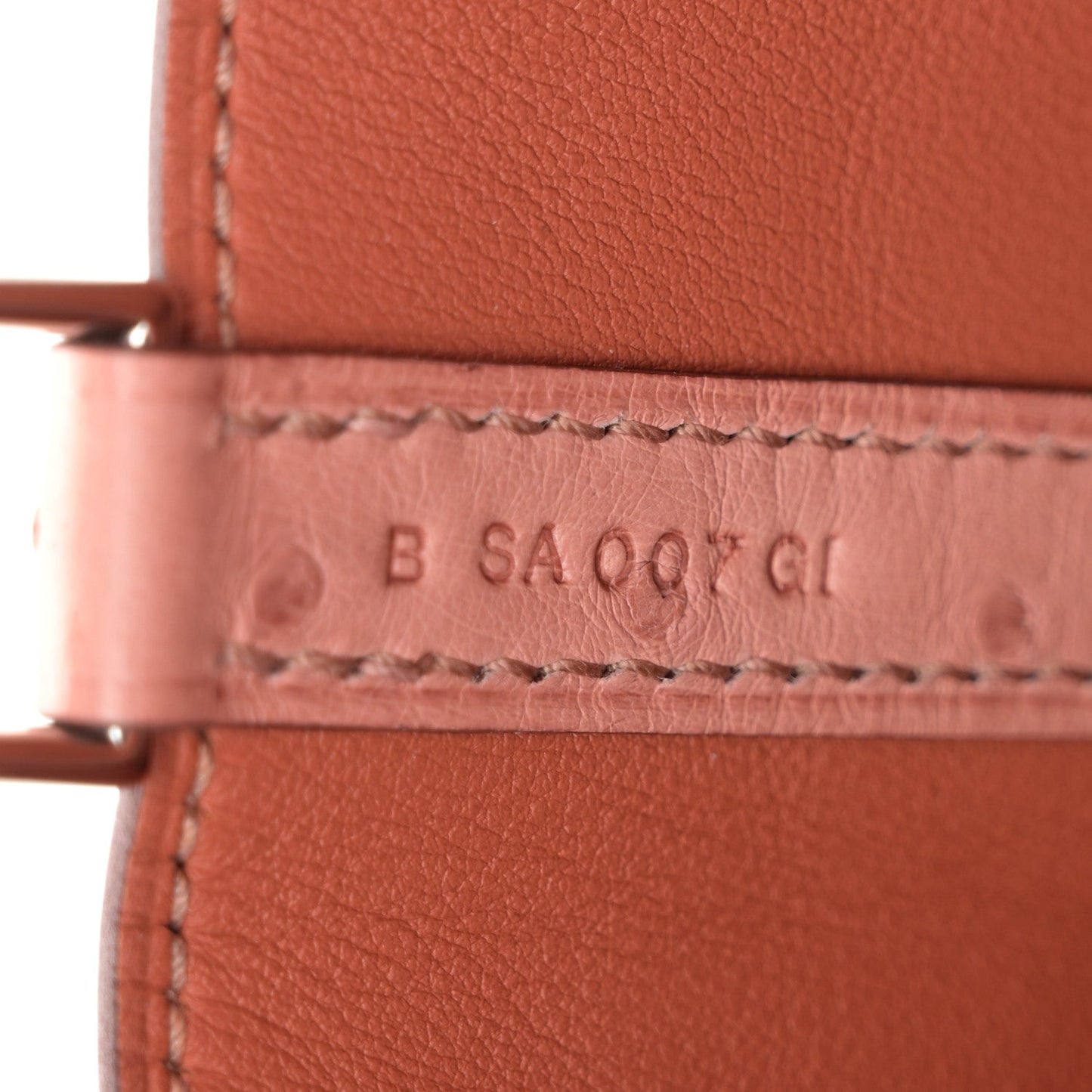 Leather bag stamp text: B SA009 CI, with stitched border detail