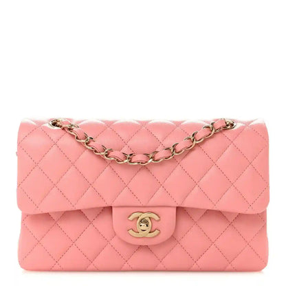 Light pink quilted small double flap bag with gold chain strap and CC logo