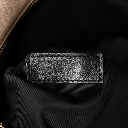 Black fabric label inside satchel interior near zipper lining