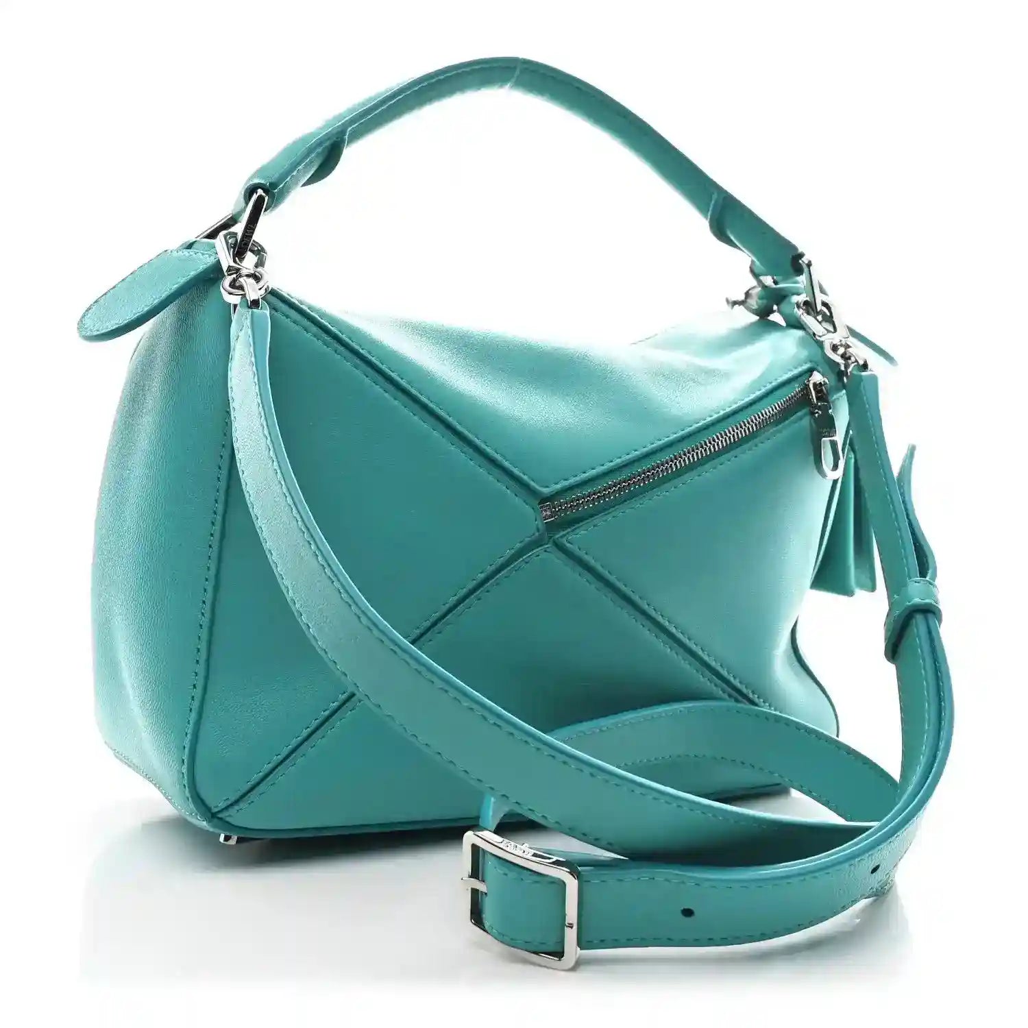 Small Puzzle bag in teal-blue leather with zip top and crossbody strap; side angle.