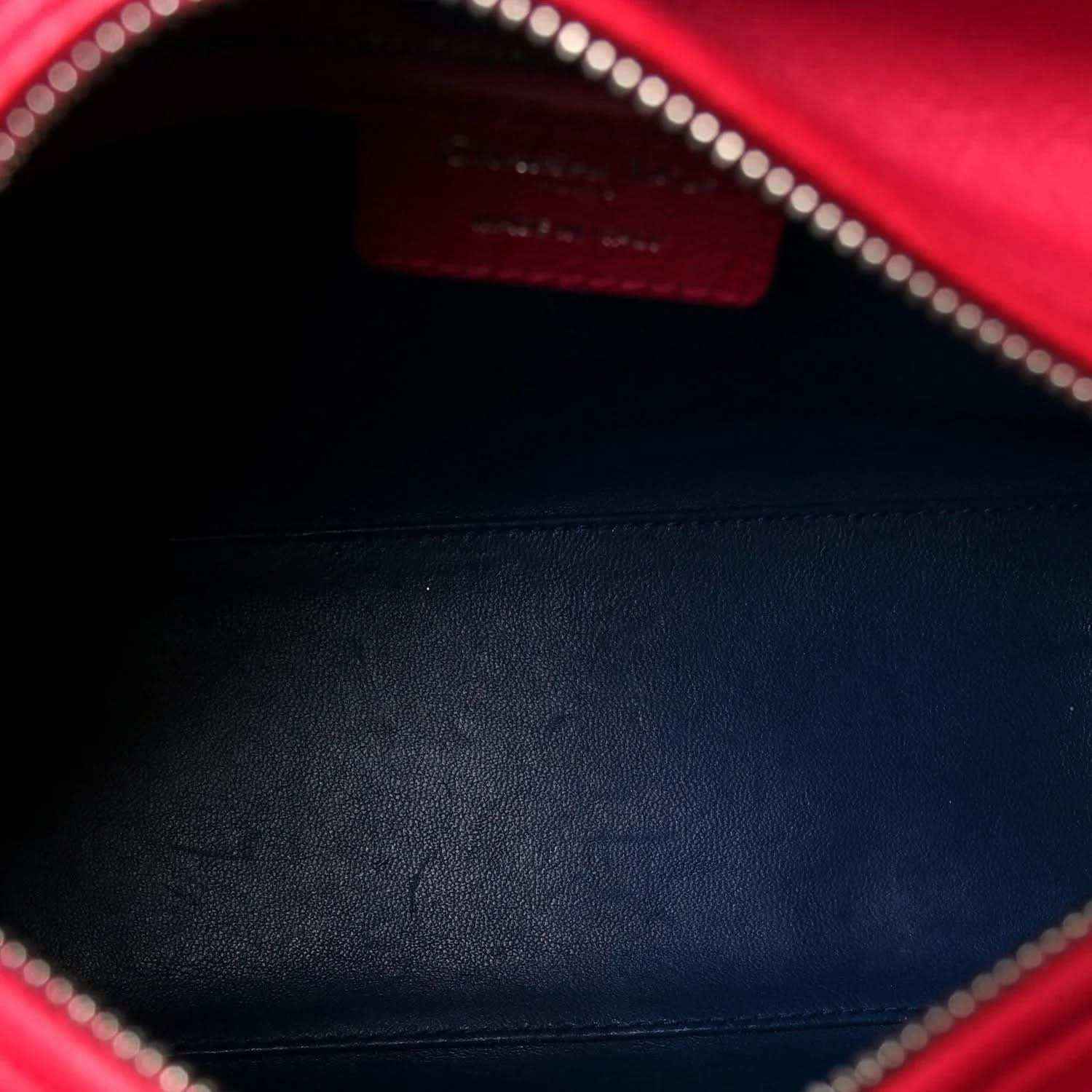 Red leather interior lining with silver zipper teeth and stitched edge