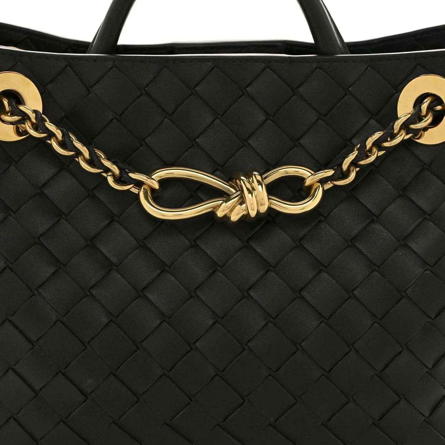 Black woven leather shoulder bag with gold-tone chain and oval clasp centerpiece