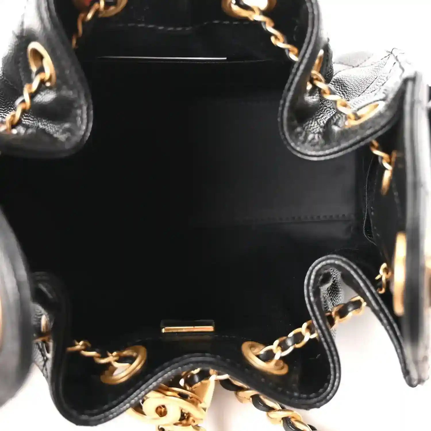 Black leather quilted mini handbag interior close-up with gold chain hardware