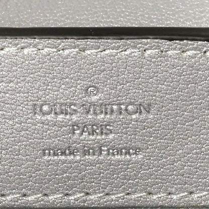 Louis Vuitton stamp on iridescent lizard mini handbag exterior