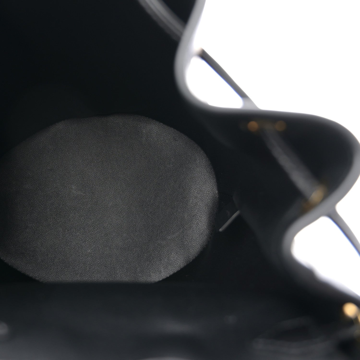 Celine Triomphe calfskin Bonnie backpack close-up of black leather texture.