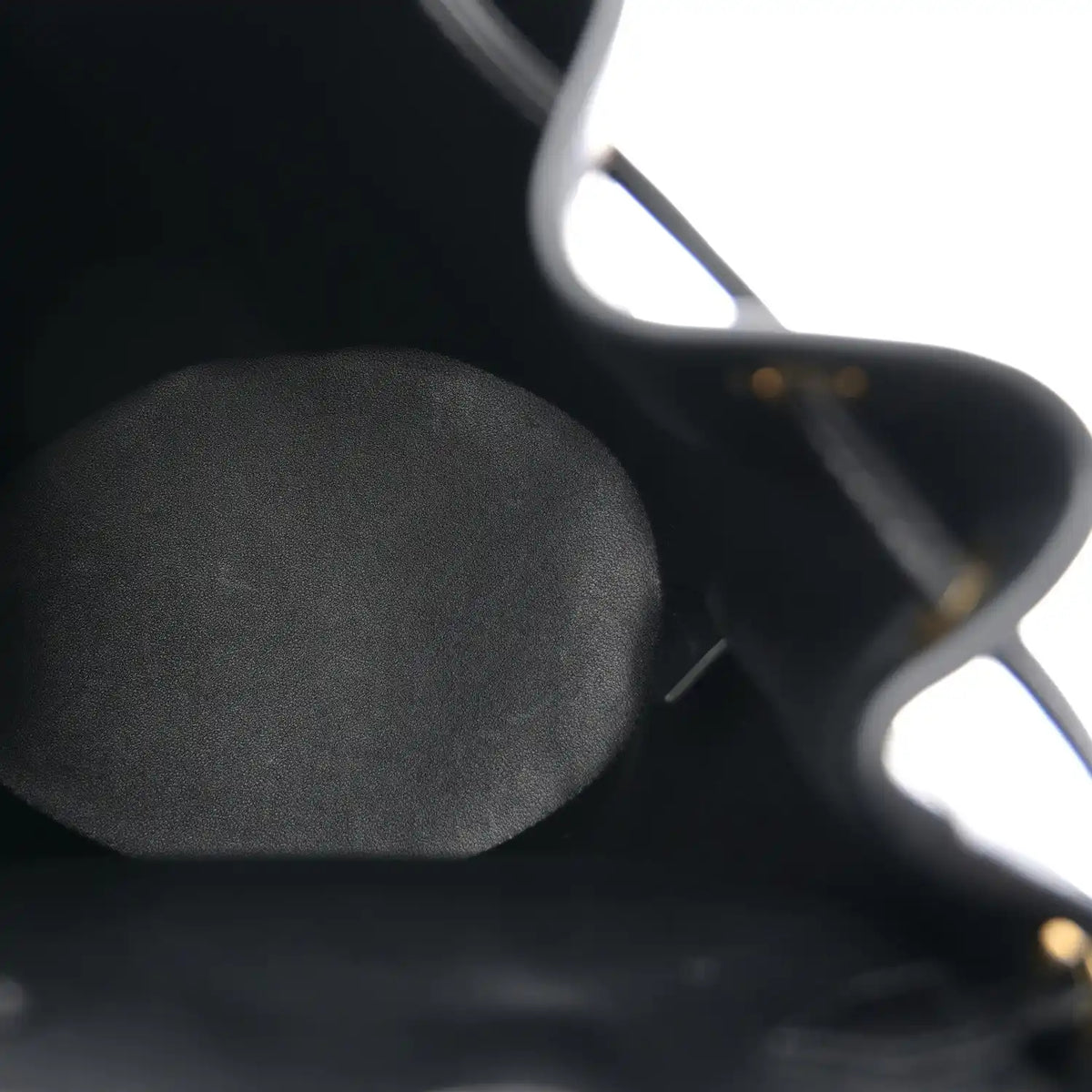 Celine Triomphe calfskin Bonnie backpack close-up of black leather texture.