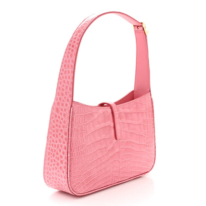 Pink alligator-textured hobo bag with top handle, curved sides, and front strap detail